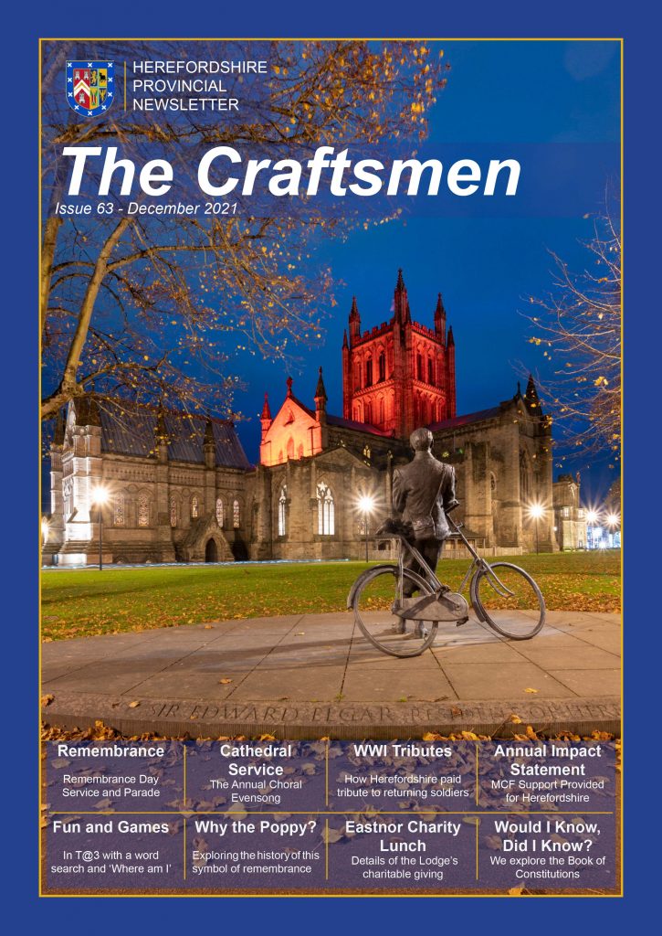 Front cover of the Craftsmen picture of Elgar leaning on his bike looking at the Cathedral tower bathed in red light for Remembrance Day