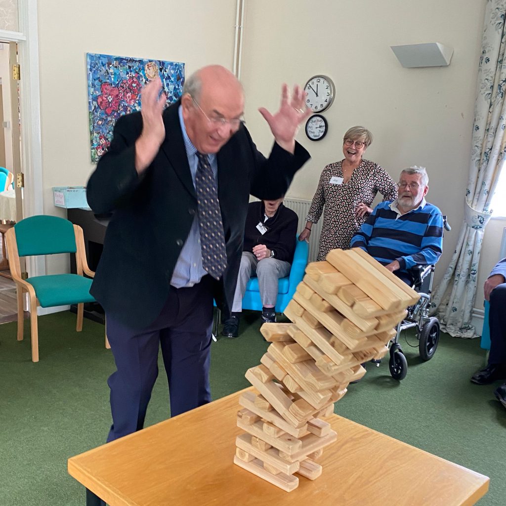 Tim B-T toppling the Jenga tower at Leominster Meeting Centre